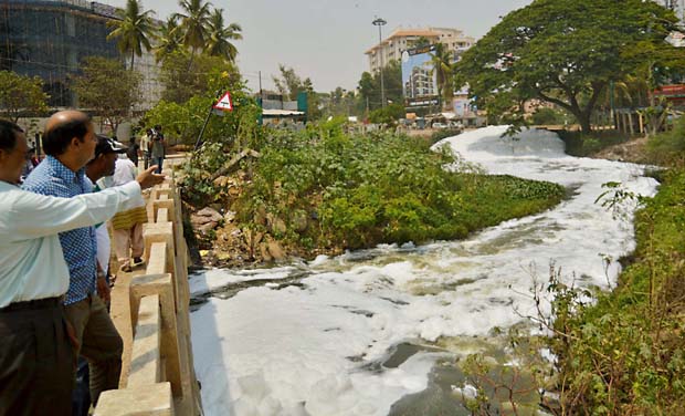 The hazardous froth from the polluted Varthur Lake is flowing outwards on the roads, causing a lot of problems to the motorists and the bad stench is causing a lot of problems to the residents, in Bengaluru The hazardous froth from the polluted Varthur Lake is flowing outwards on the roads, causing a lot of problems to the motorists and the bad stench is causing a lot of problems to the residents, in Bengaluru